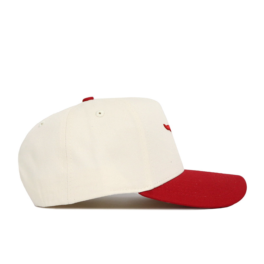 The No Rivals Classic SMU Hat (B2B) is a cream cotton baseball cap with a red brim and top button, displayed in a side view against a white background.
