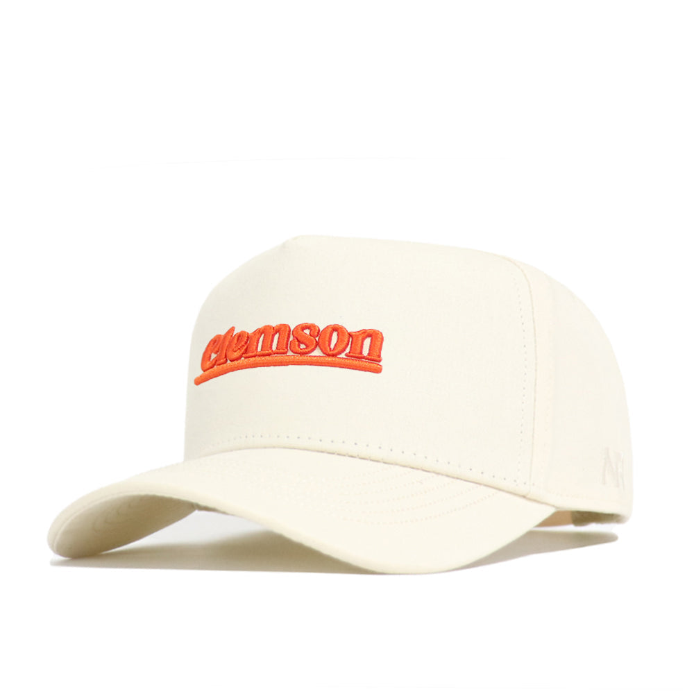 The Clemson Sideline Hat by No Rivals is a cream snapback with "clemson" embroidered in orange, made from high-quality cotton. It features a curved brim, structured fit, and a minimal, simple design.