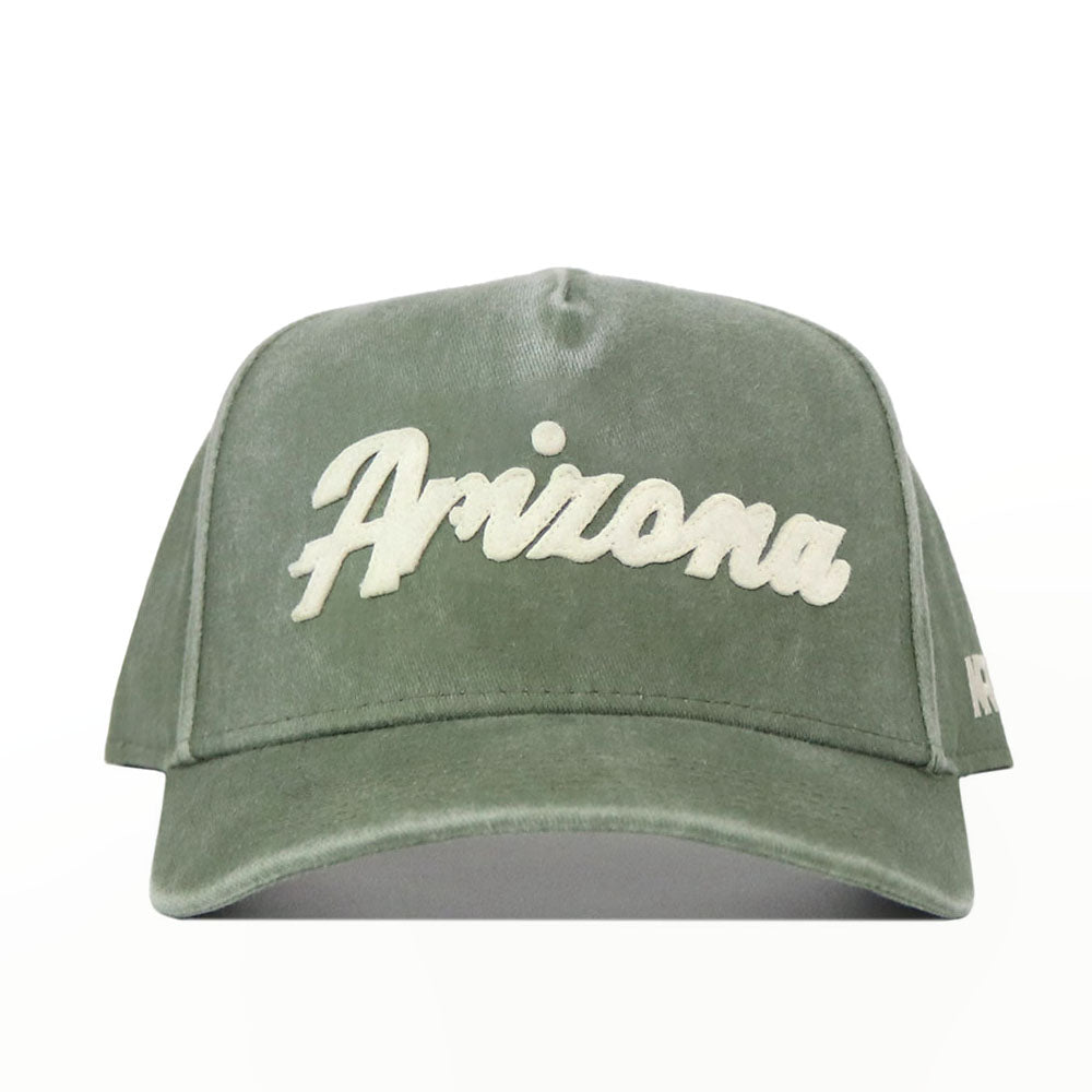 The Arizona Home Turf Hat is a green snapback featuring "Arizona" embroidered in bold white script on the front. This structured cap has a curved brim and is shown on a plain white background.