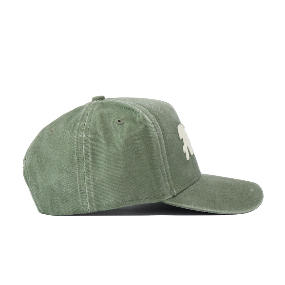 The Arizona Home Turf Hat is a green suede baseball cap with a structured fit, shown from the side and featuring a small white abstract logo on the front panel.