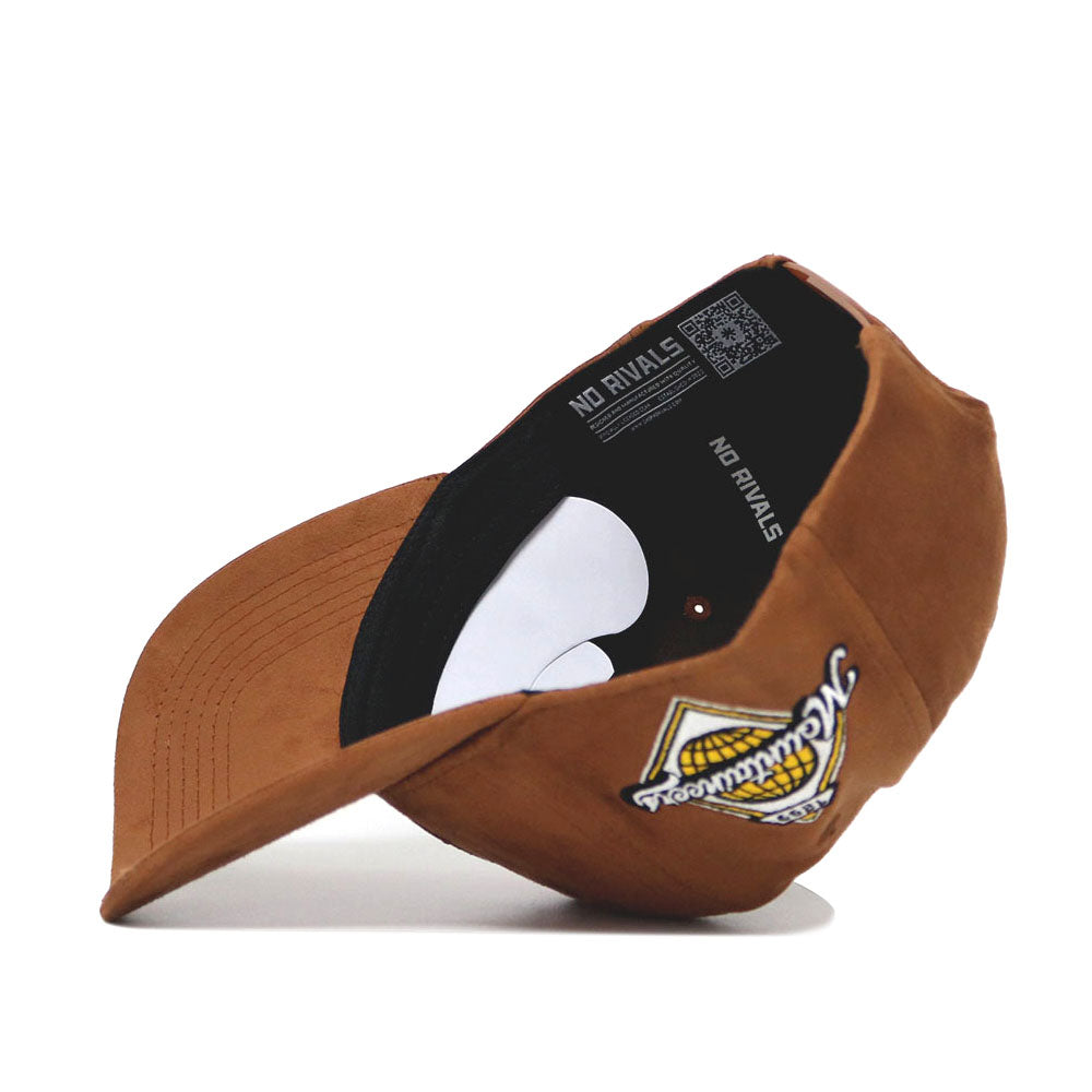 The App State Heritage Hat by No Rivals is a structured brown suede snapback with a curved brim, interior tag reading NO RIVALS, and a front left patch featuring yellow and white embroidery.