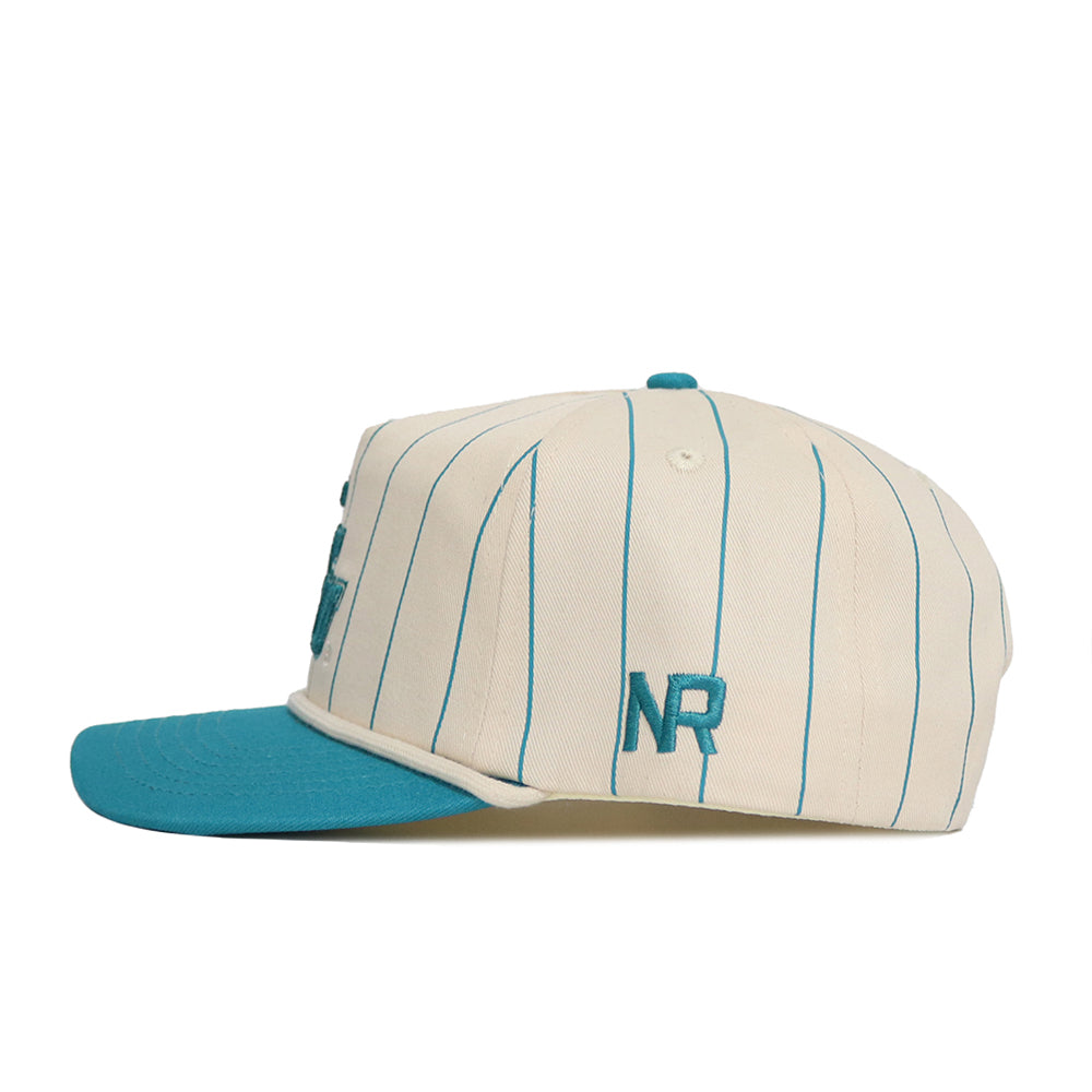 The No Rivals Coastal Carolina Pinstripe Hat features a cream base with blue vertical pinstripes, a blue brim, and blue "NR" side embroidery. Made from high-quality cotton with snap back adjustment for comfort.