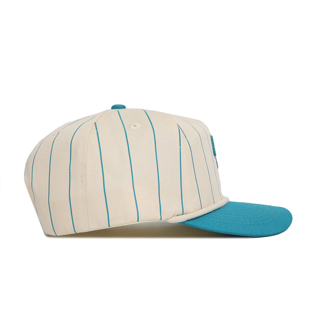 The No Rivals Coastal Carolina Pinstripe Hat features a cream base with blue vertical pinstripes and a solid blue brim, crafted from high-quality cotton, shown from the side on a plain white background.