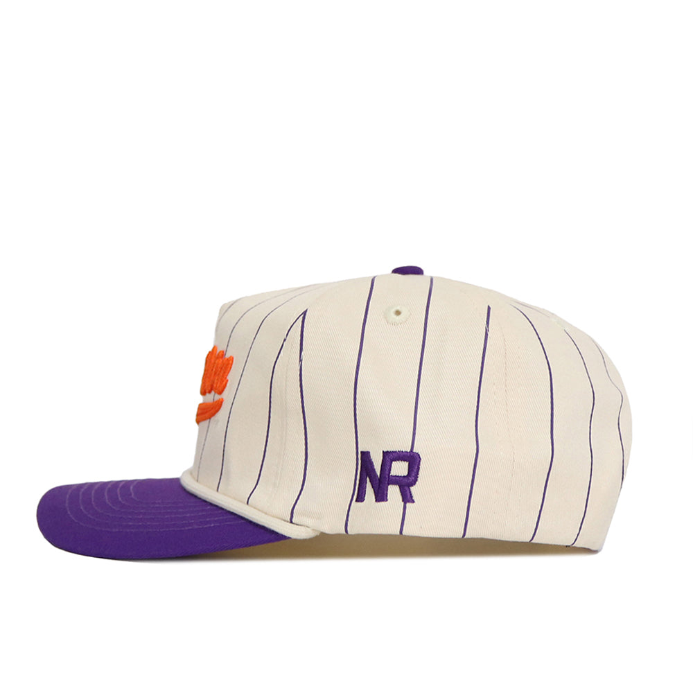 The No Rivals Clemson Pinstripe Hat features cream cotton with navy pinstripes, a purple brim, orange front embroidery, stitched purple NR letters on the side, and an adjustable snap back closure.