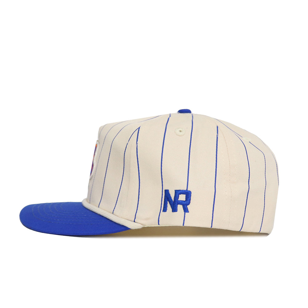 The Boise State Pinstripe Hat by No Rivals is a cream baseball cap with blue pinstripes, blue brim, and blue NR side embroidery. Made from high quality cotton, the snapback is shown from the side on a white background.