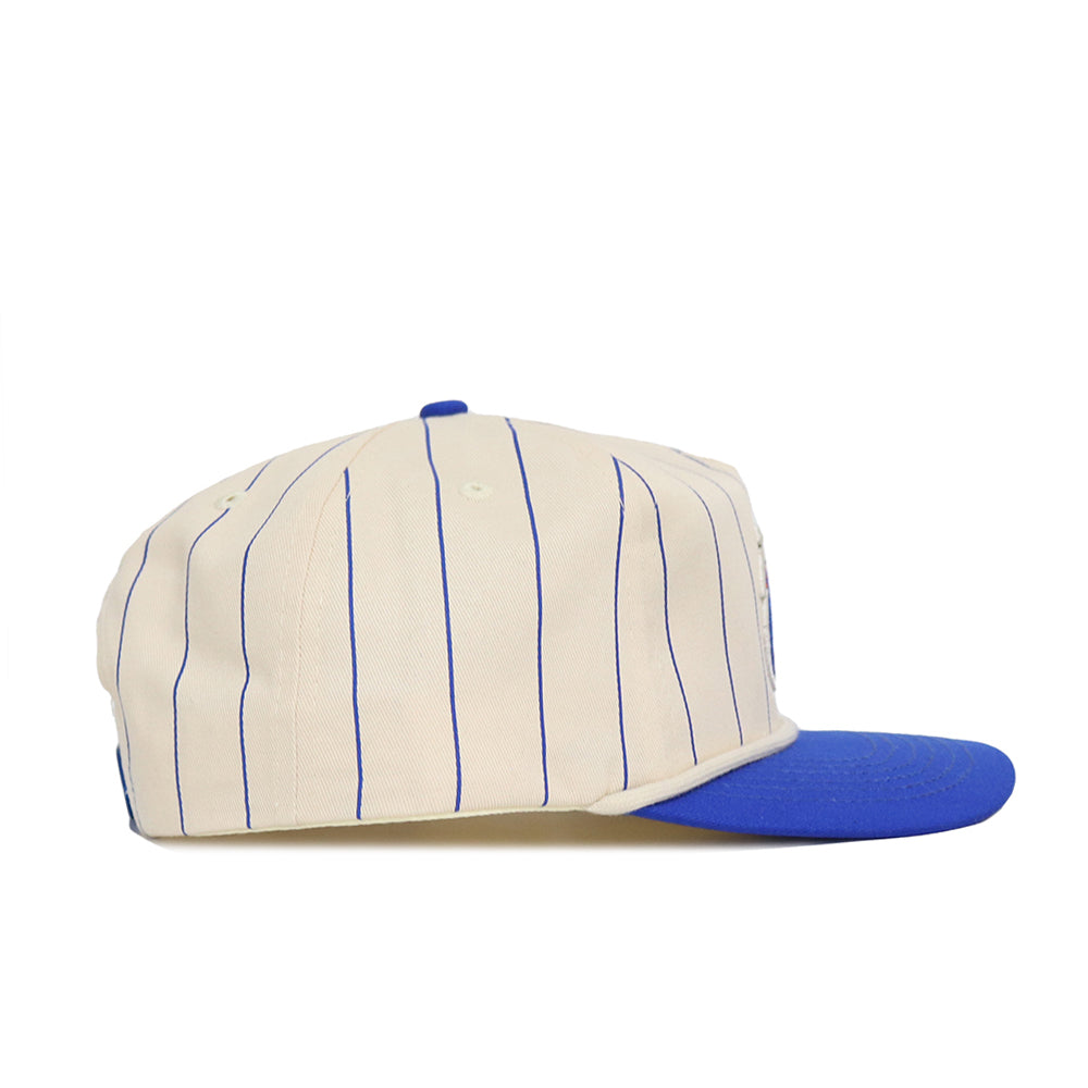 The No Rivals Boise State Pinstripe Hat is a cream snapback cap with thin blue pinstripes, a solid blue flat brim, and high-quality cotton construction, shown from the side against a white background.