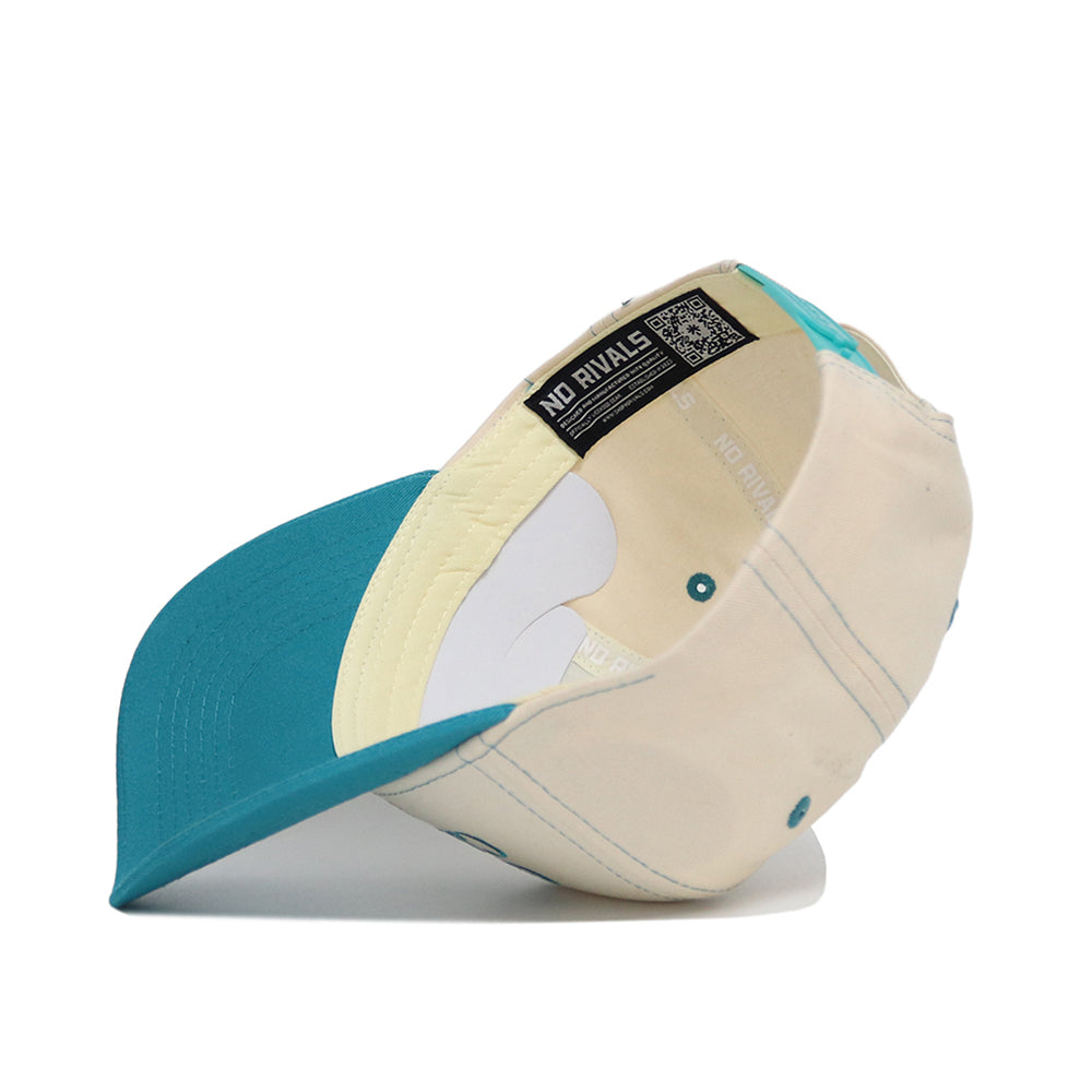 The Coastal Carolina Vintage Hat by No Rivals is a beige and teal snapback, shown from the underside with visible inner lining, structured stitching, and a "NO RIVALS" label near the adjustable band.