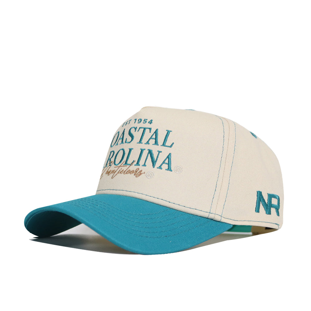 The Coastal Carolina Vintage Hat by No Rivals is a beige and teal snapback with "COASTAL CAROLINA" and "NR" embroidered on quality cotton. It features a structured fit, teal brim and details, beige body, and teal stitching.