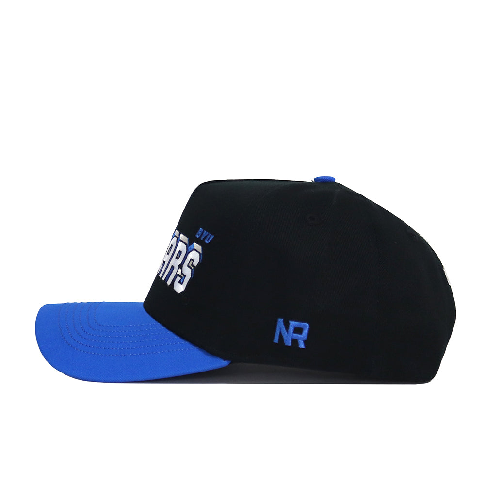 The BYU Courtside Hat is a black snapback with a blue brim and button, made from high-quality cotton. It features white COUGARS BYU text on the side, blue NR initials on the back, and is an officially licensed accessory.