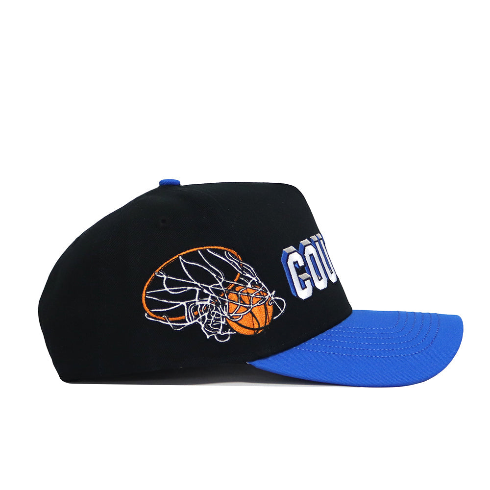 The BYU Courtside Hat is a black snapback with a blue brim, made from high-quality cotton, featuring an embroidered orange basketball through a white net and "COURT" in bold white letters on the side.