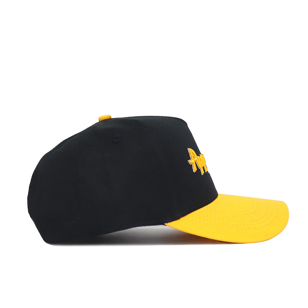 The No Rivals App State Retro Script Hat is a black cotton baseball cap with a yellow brim and button, featuring yellow embroidered text on the side. Shown in side profile against a white background.