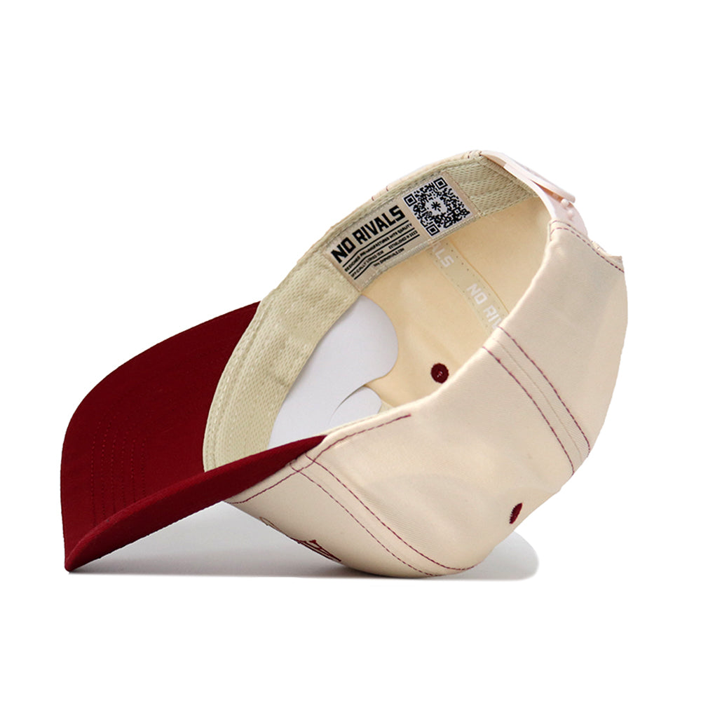 An Alabama Vintage Hat by No Rivals is pictured upside down, displaying its cream crown with visible stitching, dark red (maroon) brim, and inner labels—including one marked "NO RIVALS.