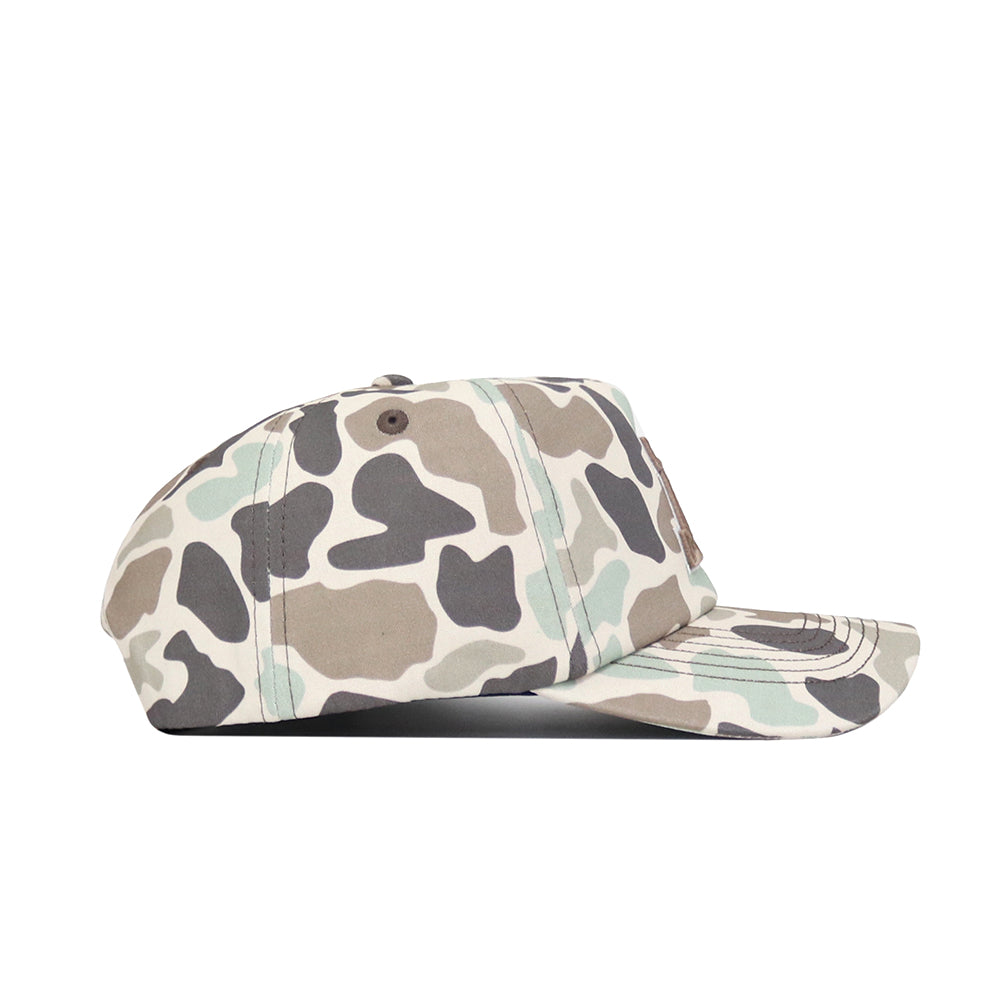 A side view of the No Rivals Arizona Huntsman Hat, a 5-panel cap in beige, brown, gray, and light green duck camo with a curved brim, snapback closure, and visible stitching.