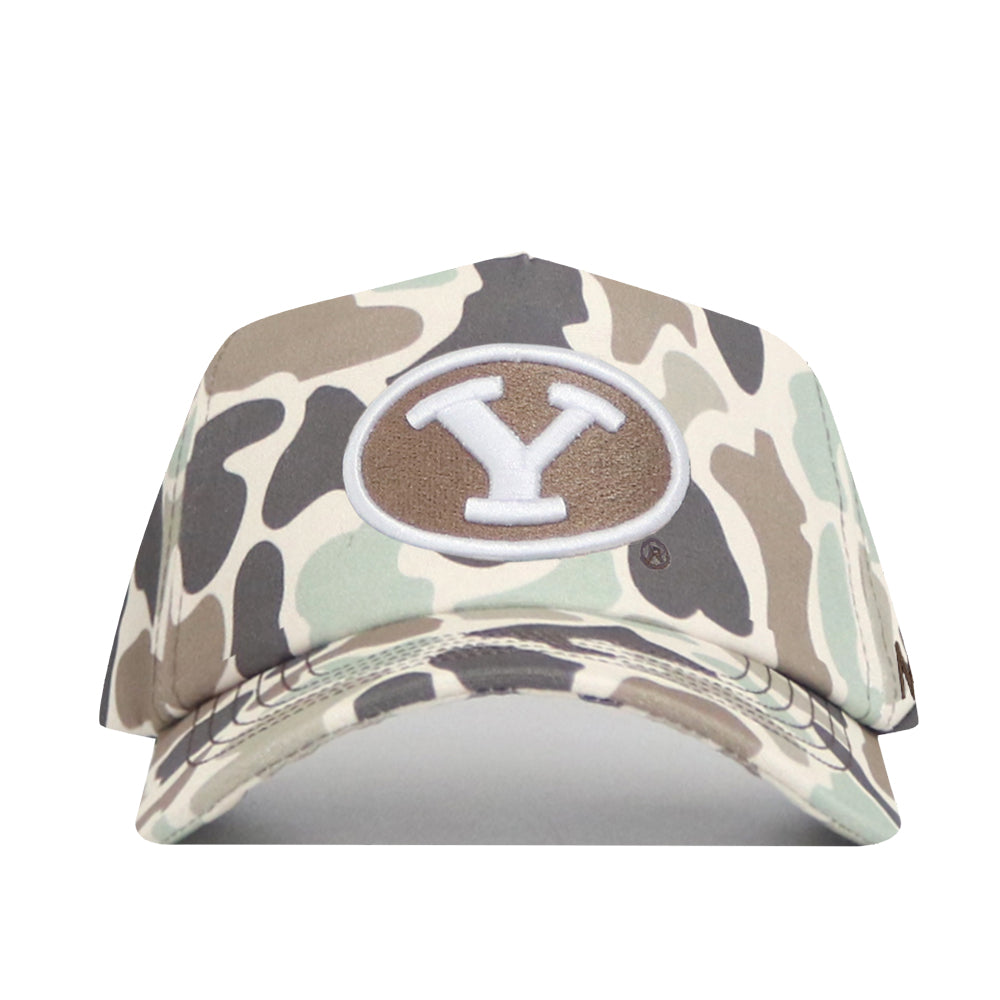 The BYU Huntsman Hat by No Rivals is a duck camo 5-panel baseball cap featuring a brown oval front patch with a large white Y outlined in gray.