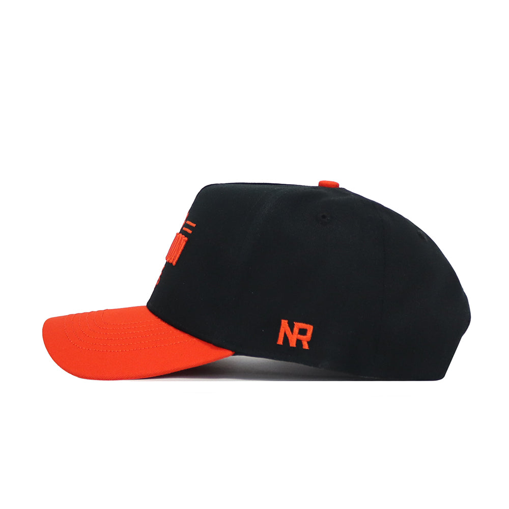 The No Rivals Clemson Tailgate Hat is a black snapback cap with an orange brim and top button, made from high-quality cotton. It features orange "NR" embroidery on the side and has a structured fit, displayed in side profile against a white background.