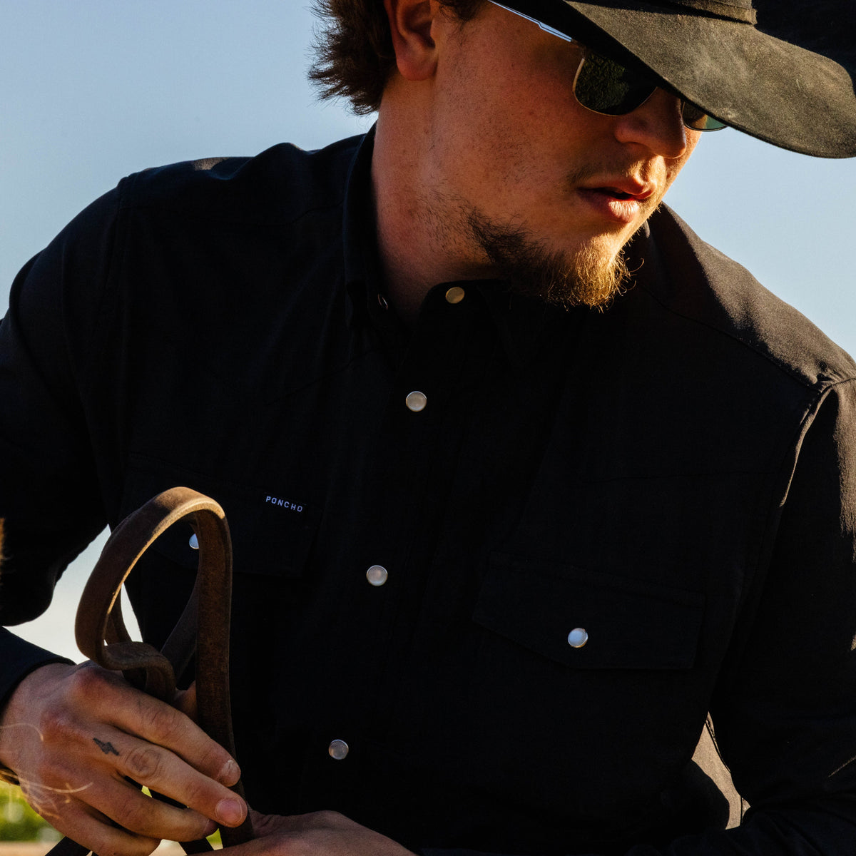 closeup man with black pearl snap shirt