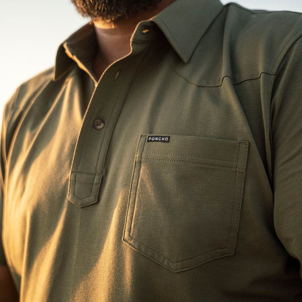 man wearing green polo shirt