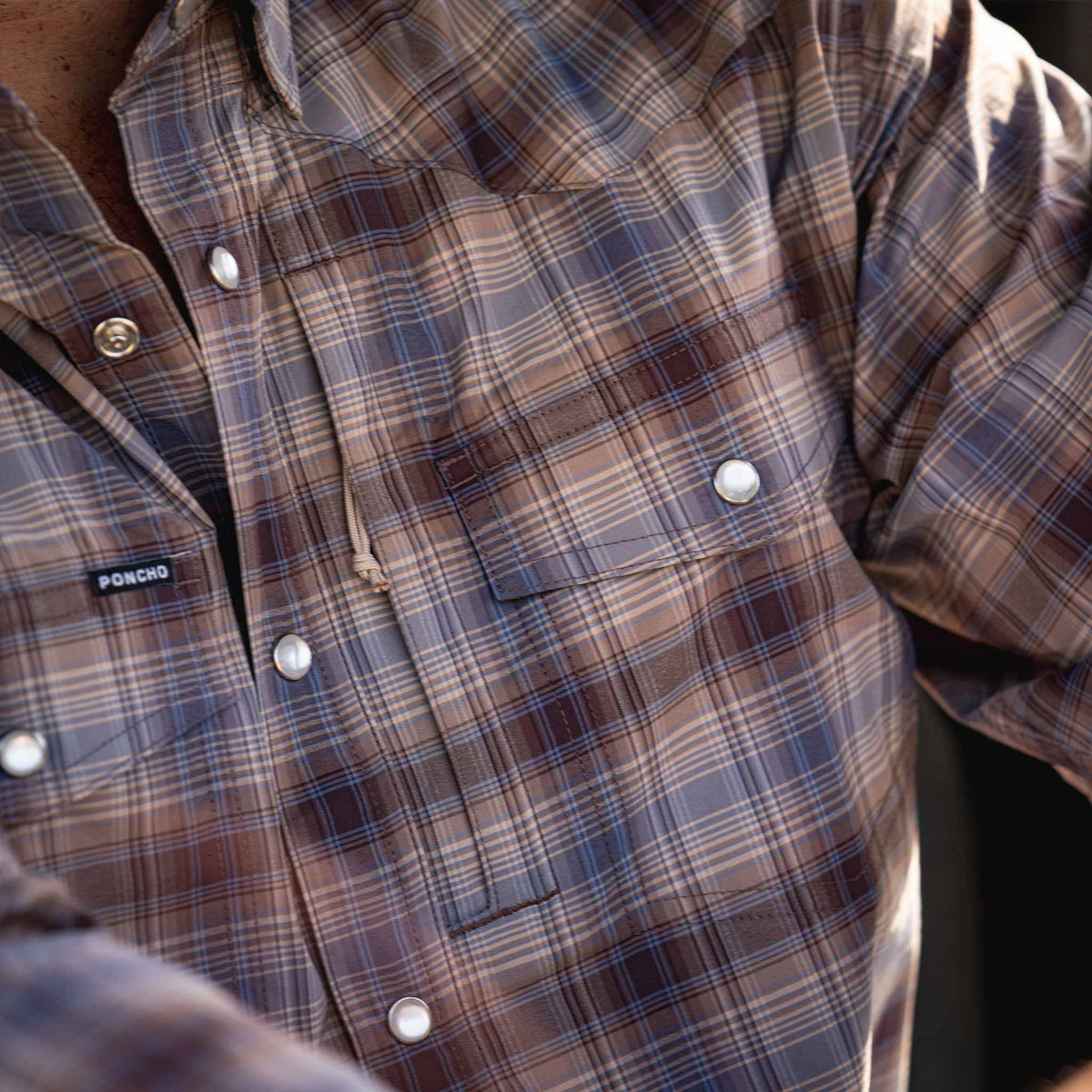 close up of brown blue plaid shirt