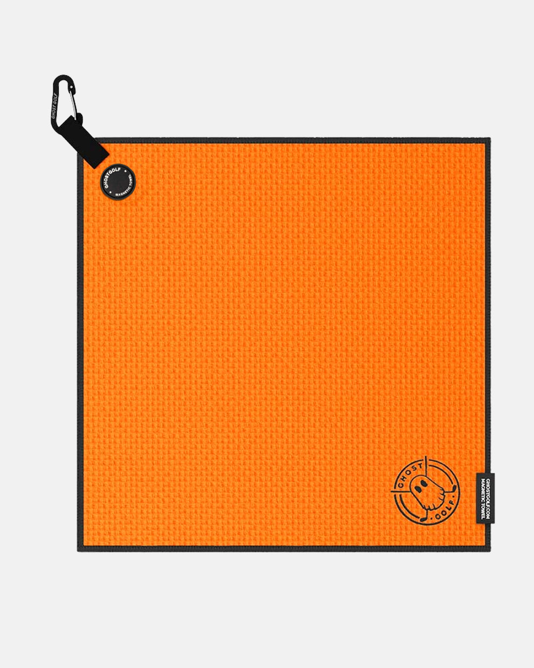 Product shot of Orange Ghost Golf Magnetic Greenside Towel with emblem logo near the bottom and carabiner clip at the top #color_orange