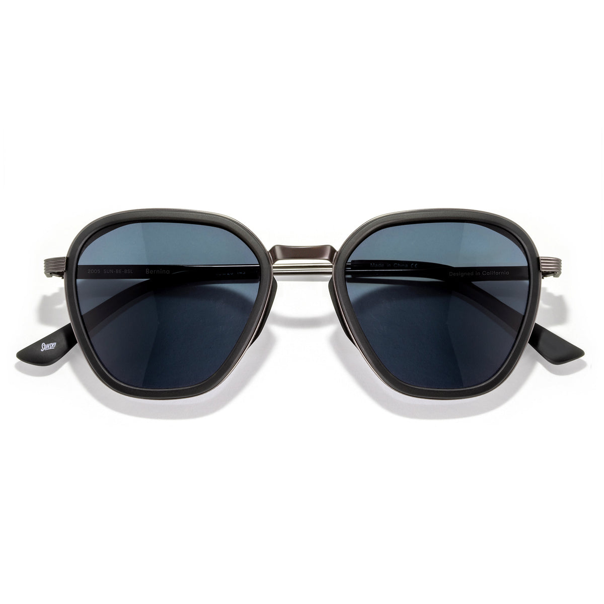Sunglasses with dark lenses and gold frame on a white background