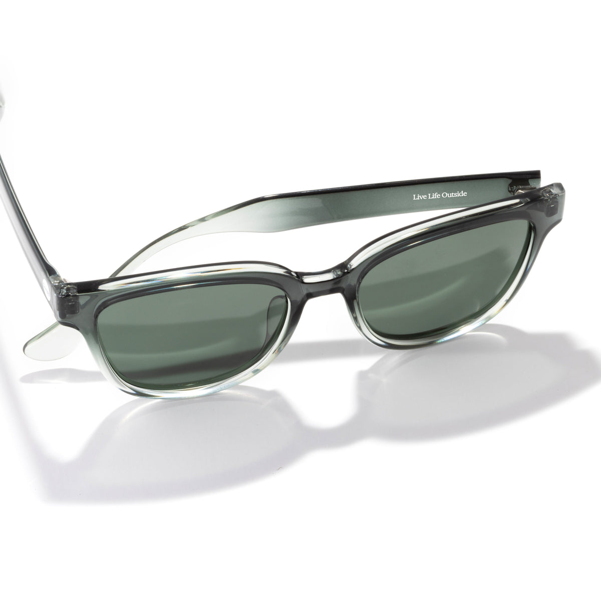 Sunglasses with a clear frame and dark lenses on a white background
