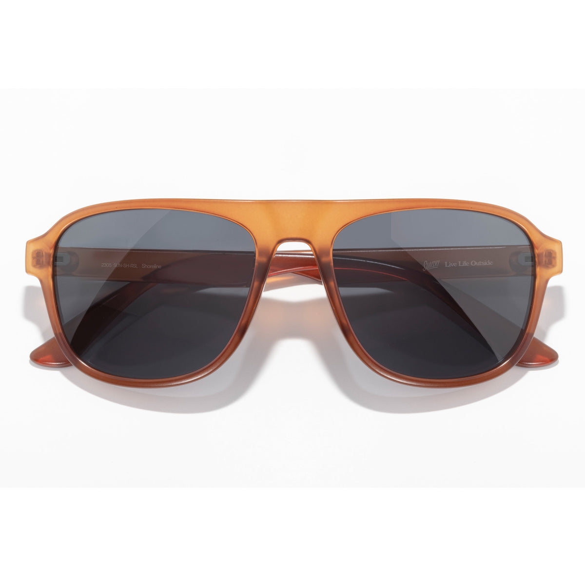 Sunglasses with brown frame and dark lenses on a white background