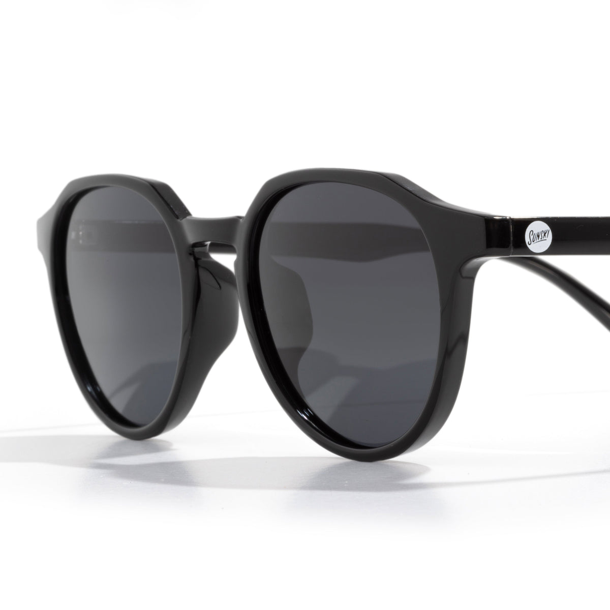 Black sunglasses with dark lenses on a white background