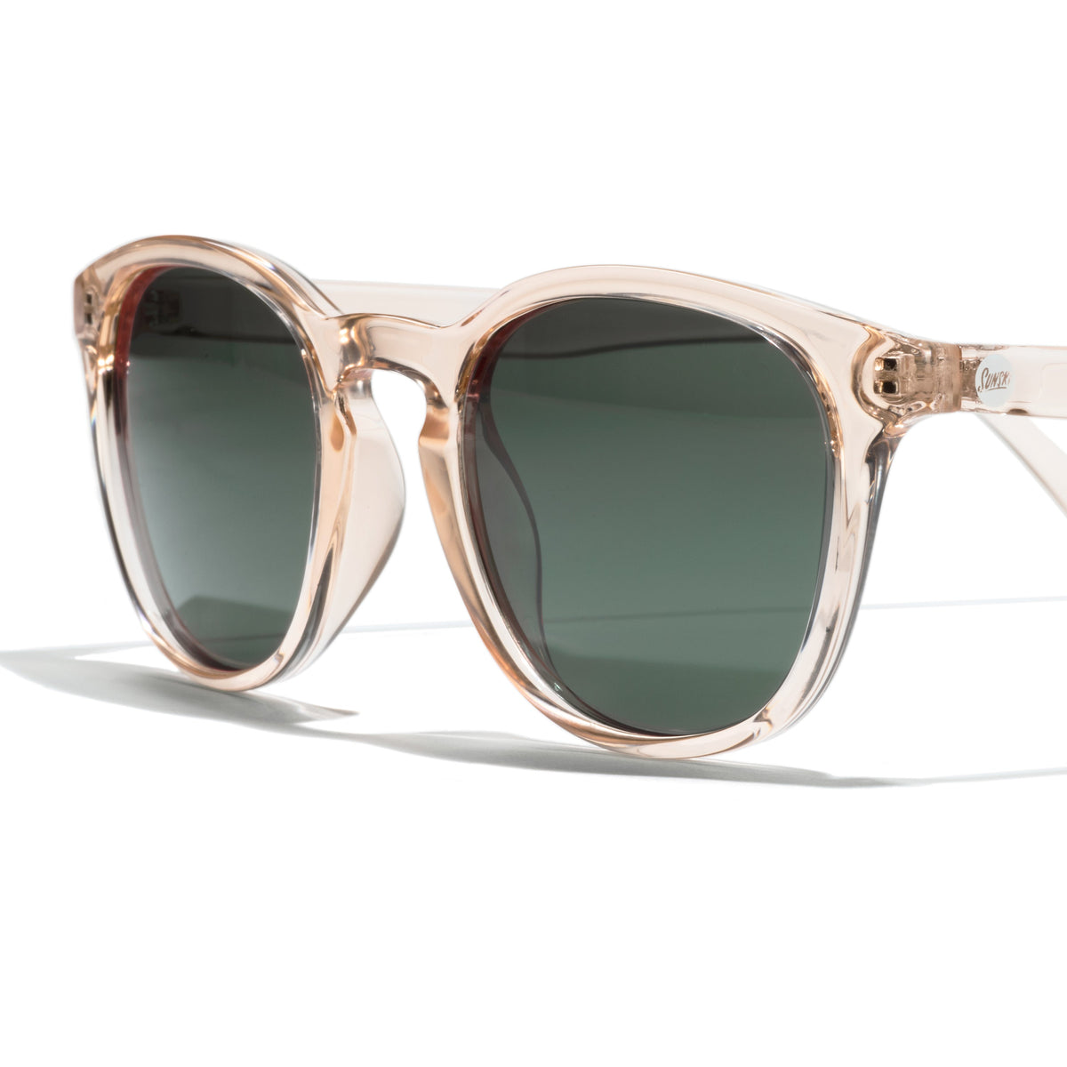 Sunglasses with a beige frame and dark lenses on a white background