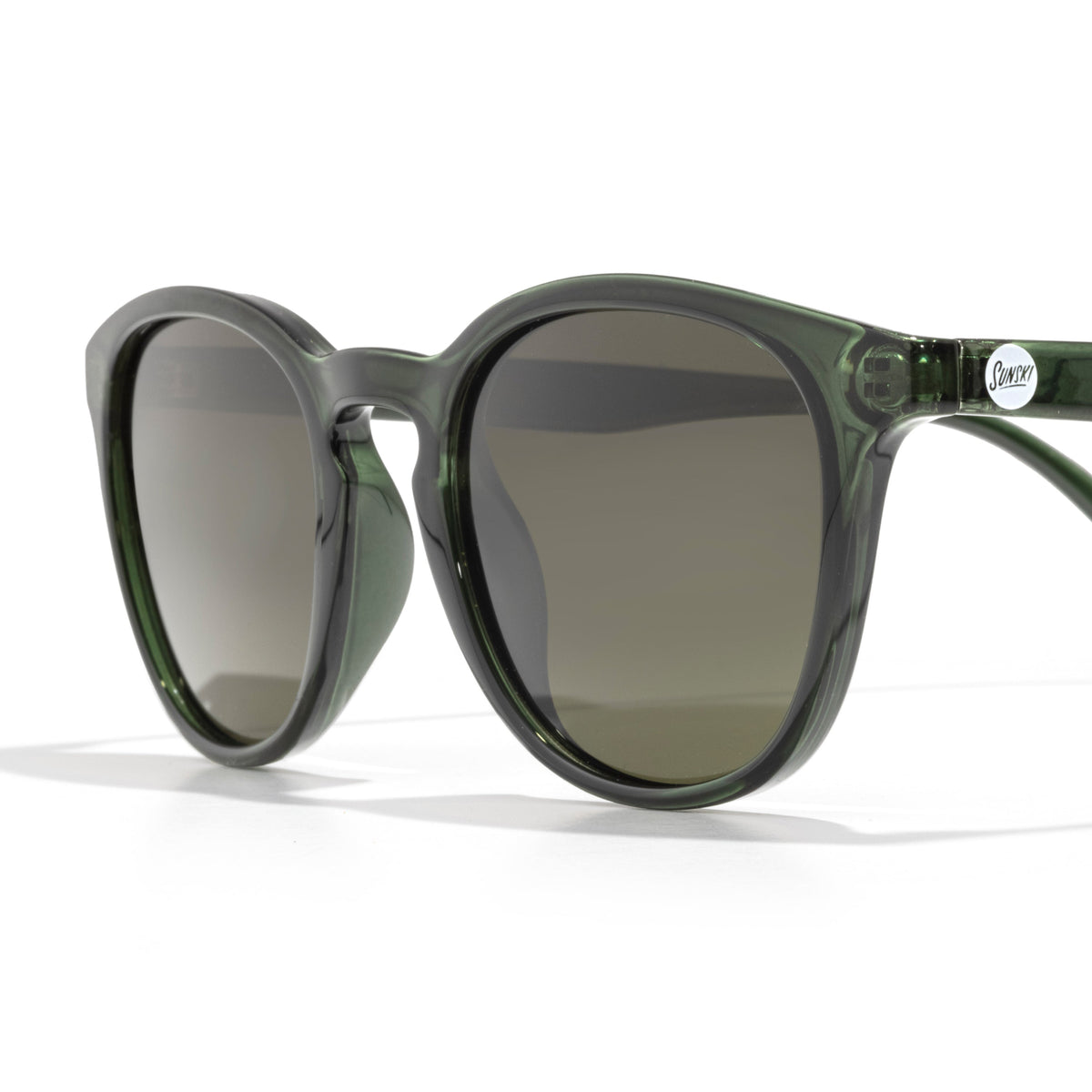 Green sunglasses with dark lenses on a white background