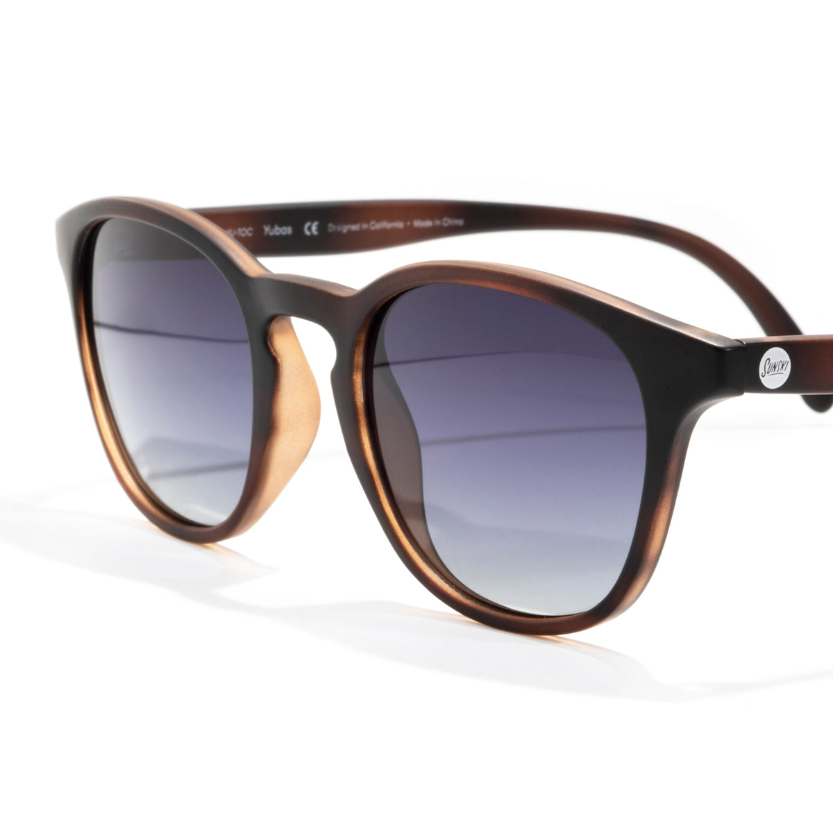 Sunglasses with a brown and black frame on a white background