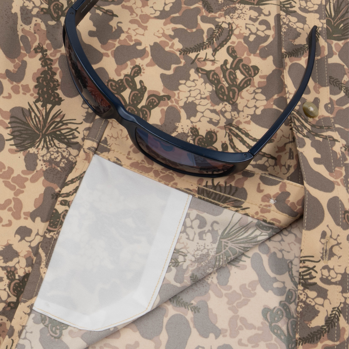 Closeup of sunglasses with lens cleaner on shirt
