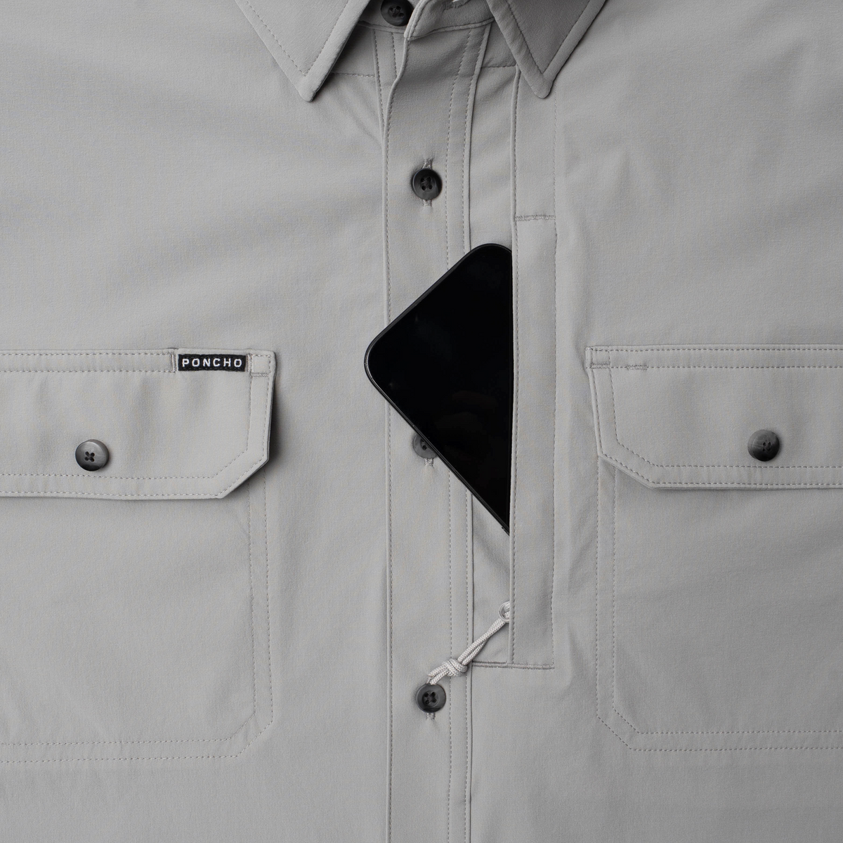 Phone in chest zipper pocket of shirt