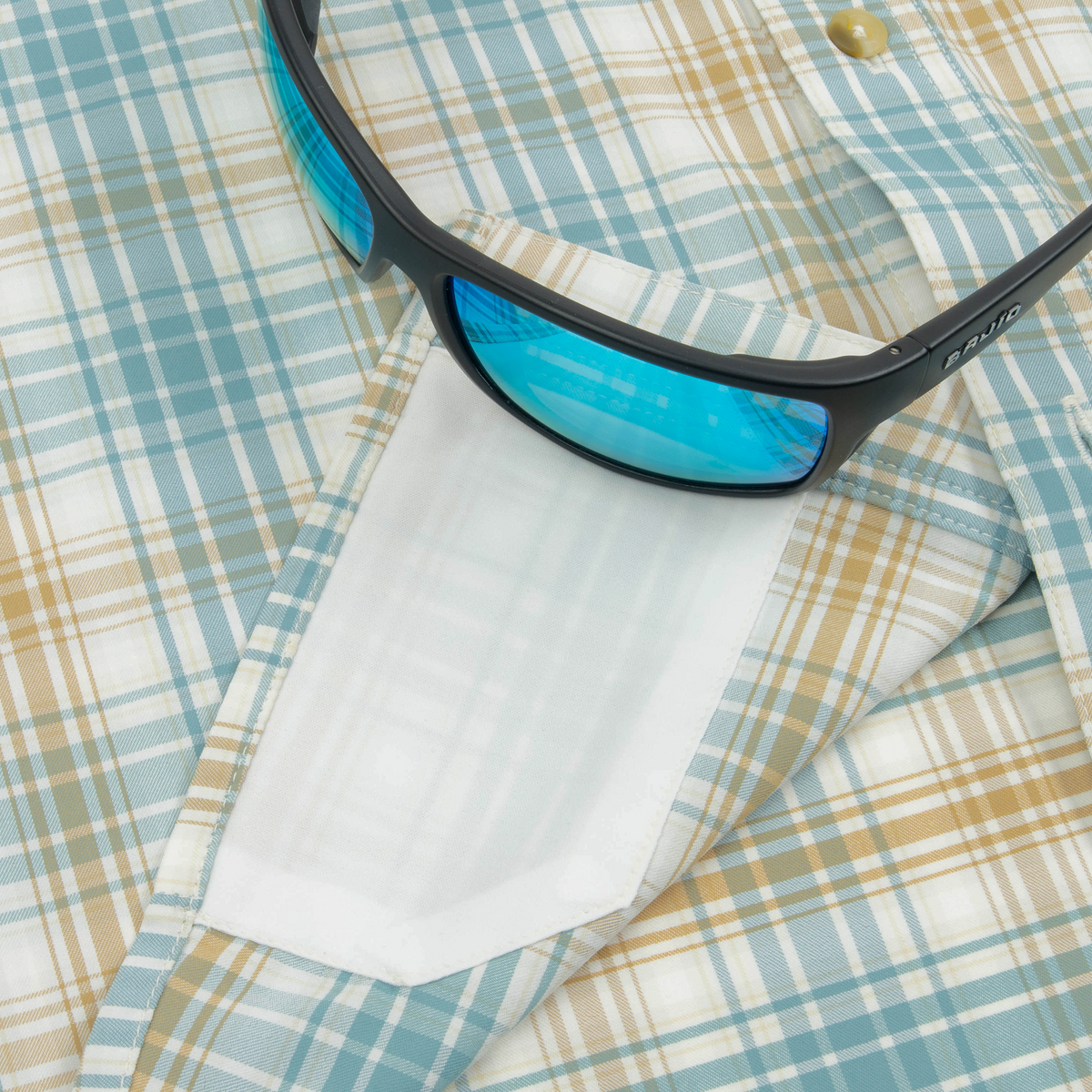 sunglasses with lens cleaner on shirt