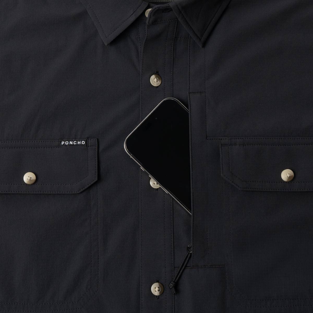 Phone in chest zipper pocket of shirt