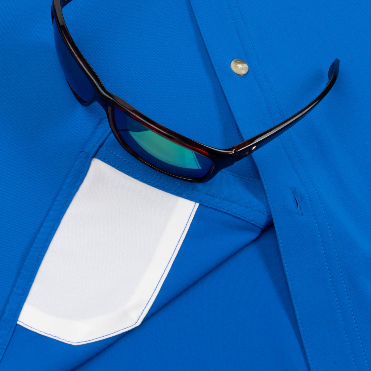 Closeup of sunglasses with lens cleaner on shirt