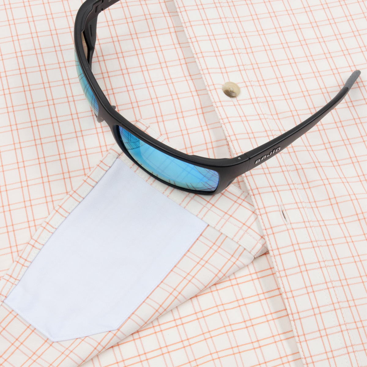 sunglasses with lens cleaner on shirt
