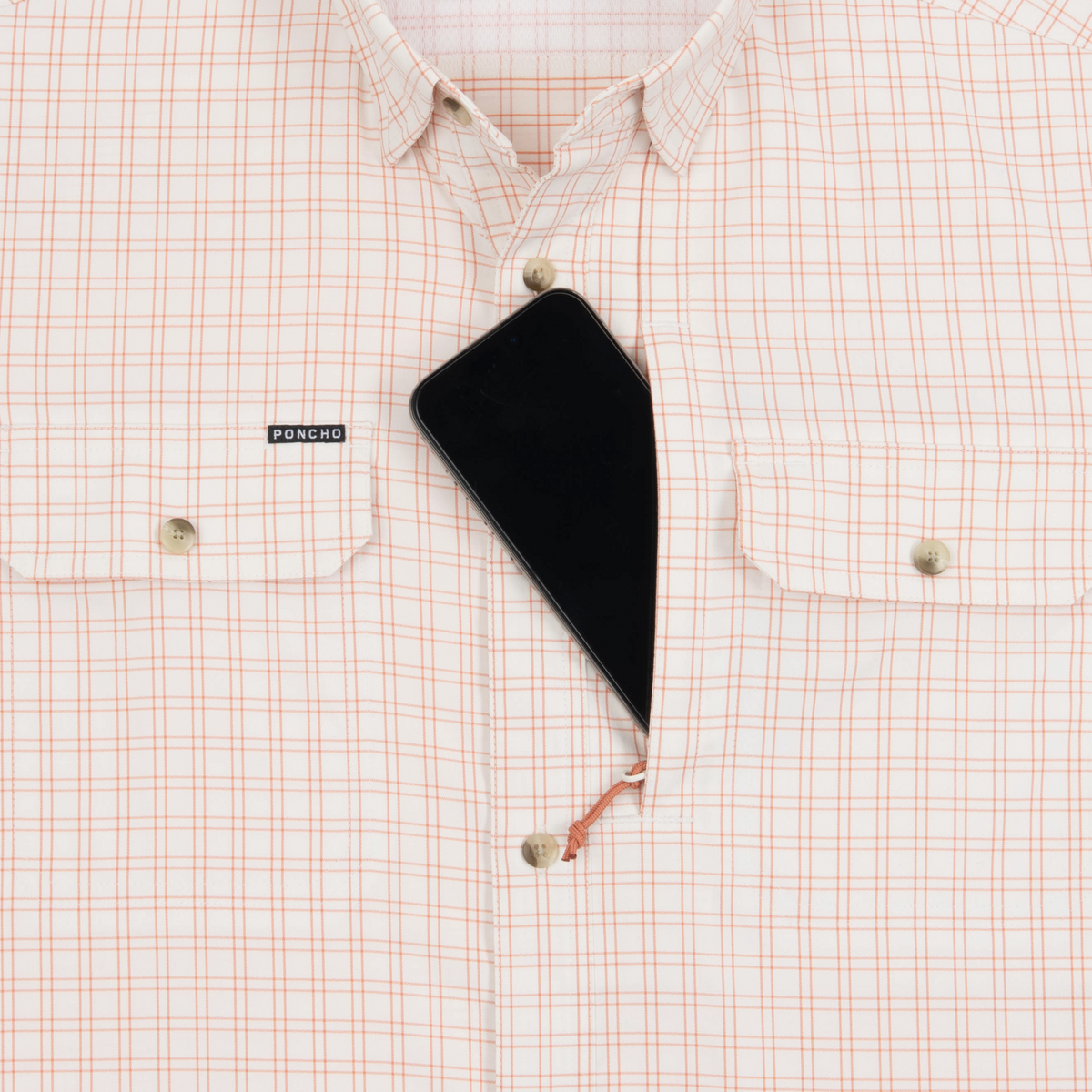 phone in chest zipper pocket of shirt