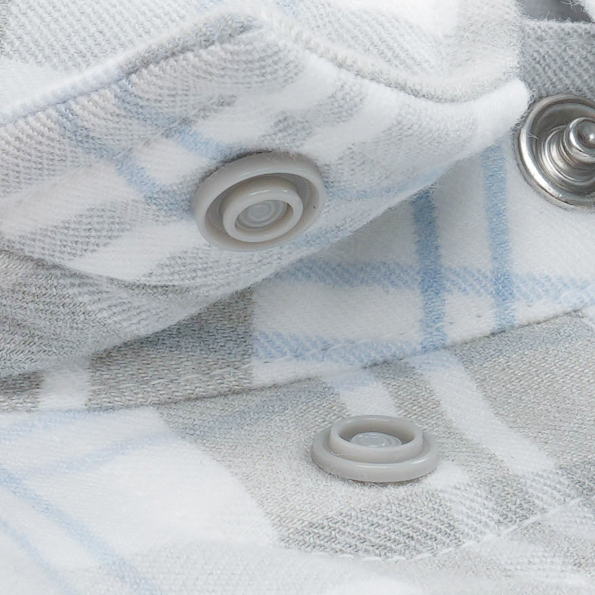 The Pearl Cat white and blue plaid western pearl snap shirt detail for outdoor wear