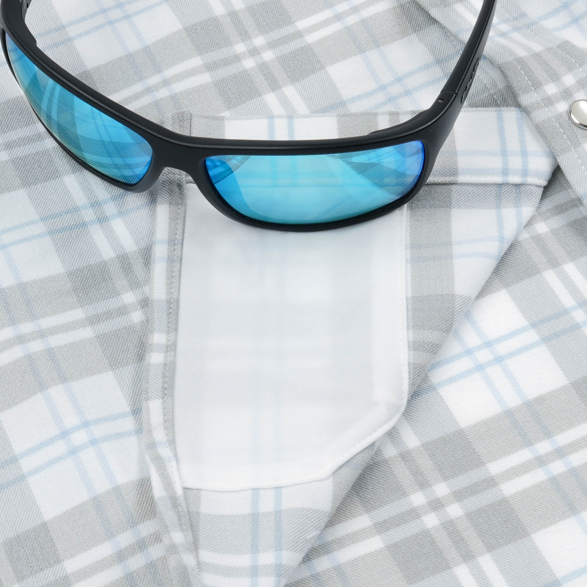 The Pearl Cat light blue and gray plaid western pearl snap shirt with sunglasses for outdoor wear