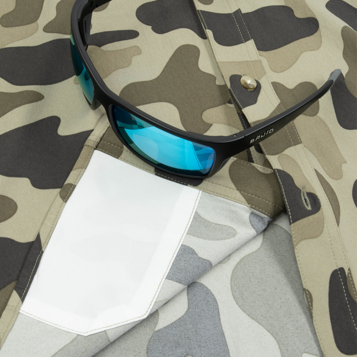 Closeup of sunglasses with lens cleaner on shirt