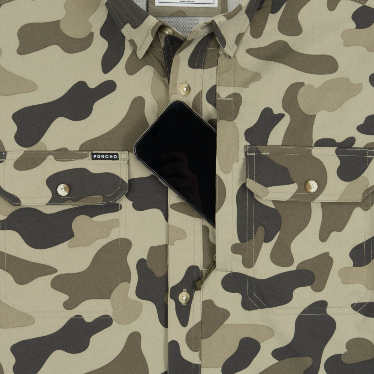 Phone in chest zipper pocket of shirt