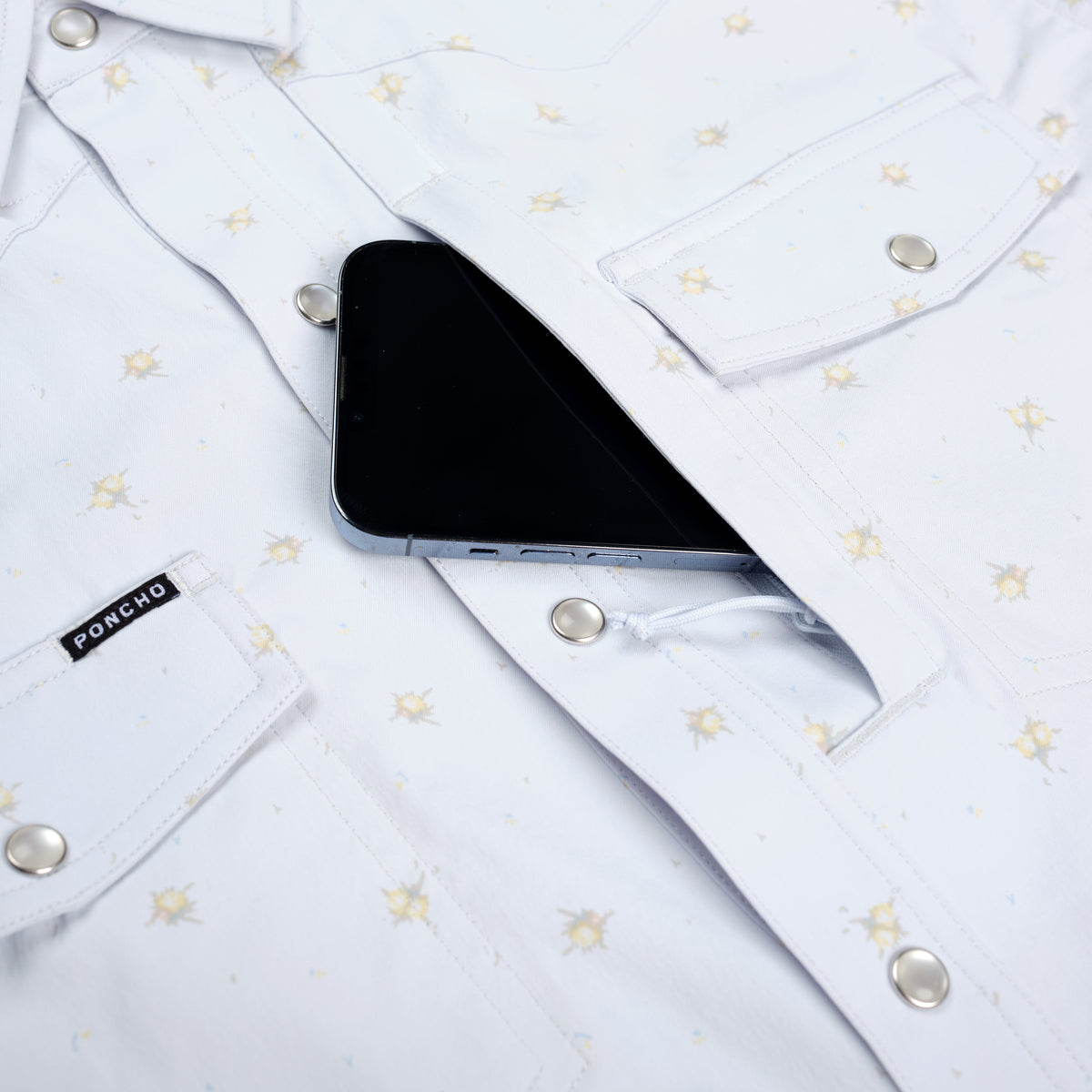 phone going into chest pocket of blue floral shirt