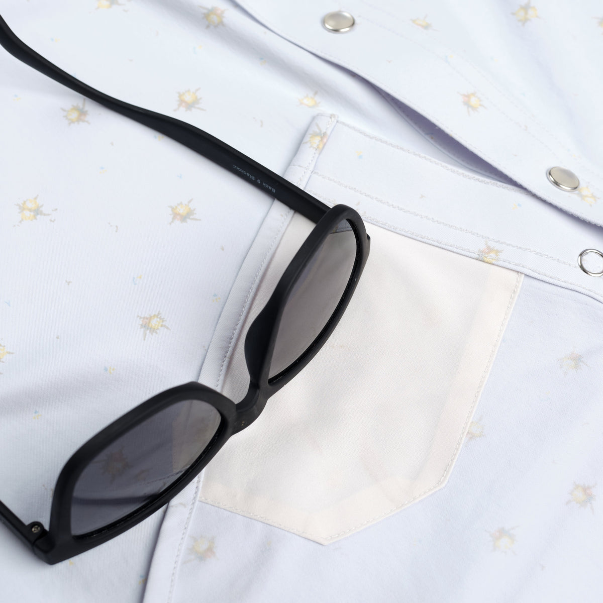 closeup of blue floral shirt lens cleaner