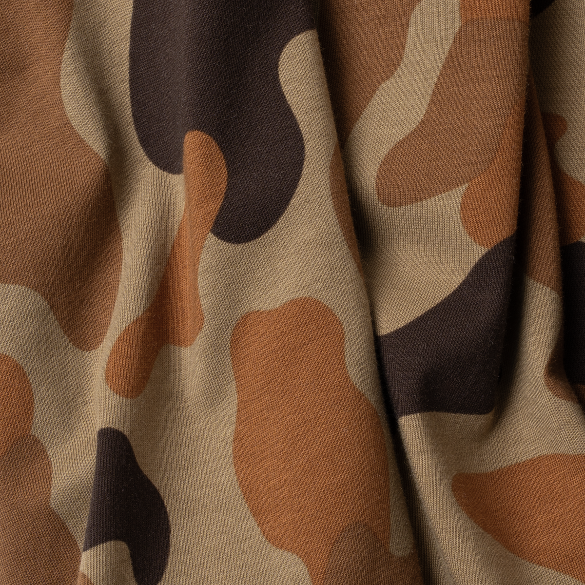 The Dove Stool fabric close-up showing brown and tan camouflage pattern in soft folds
