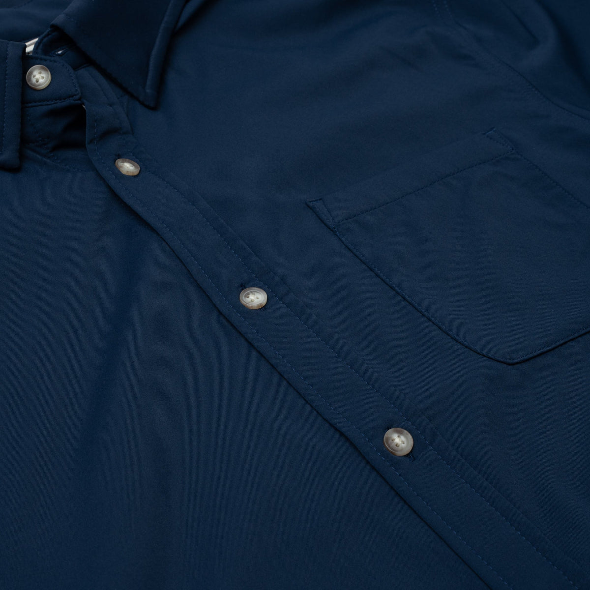 Close up photo of navy button down shirt with one pocket