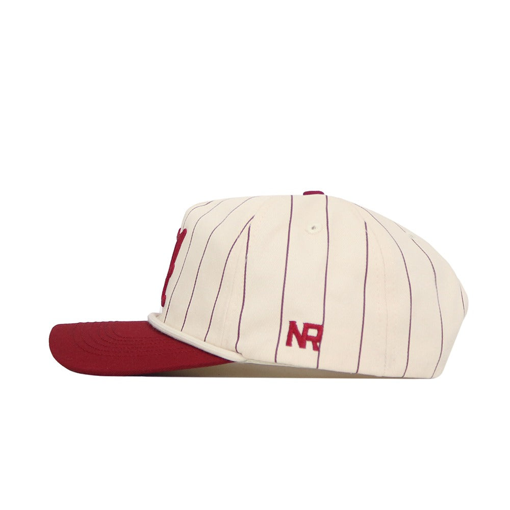 The No Rivals Alabama Pinstripe Hat features cream cotton fabric with thin maroon vertical pinstripes, a maroon brim, snapback closure, and "NR" embroidered in maroon on the side.