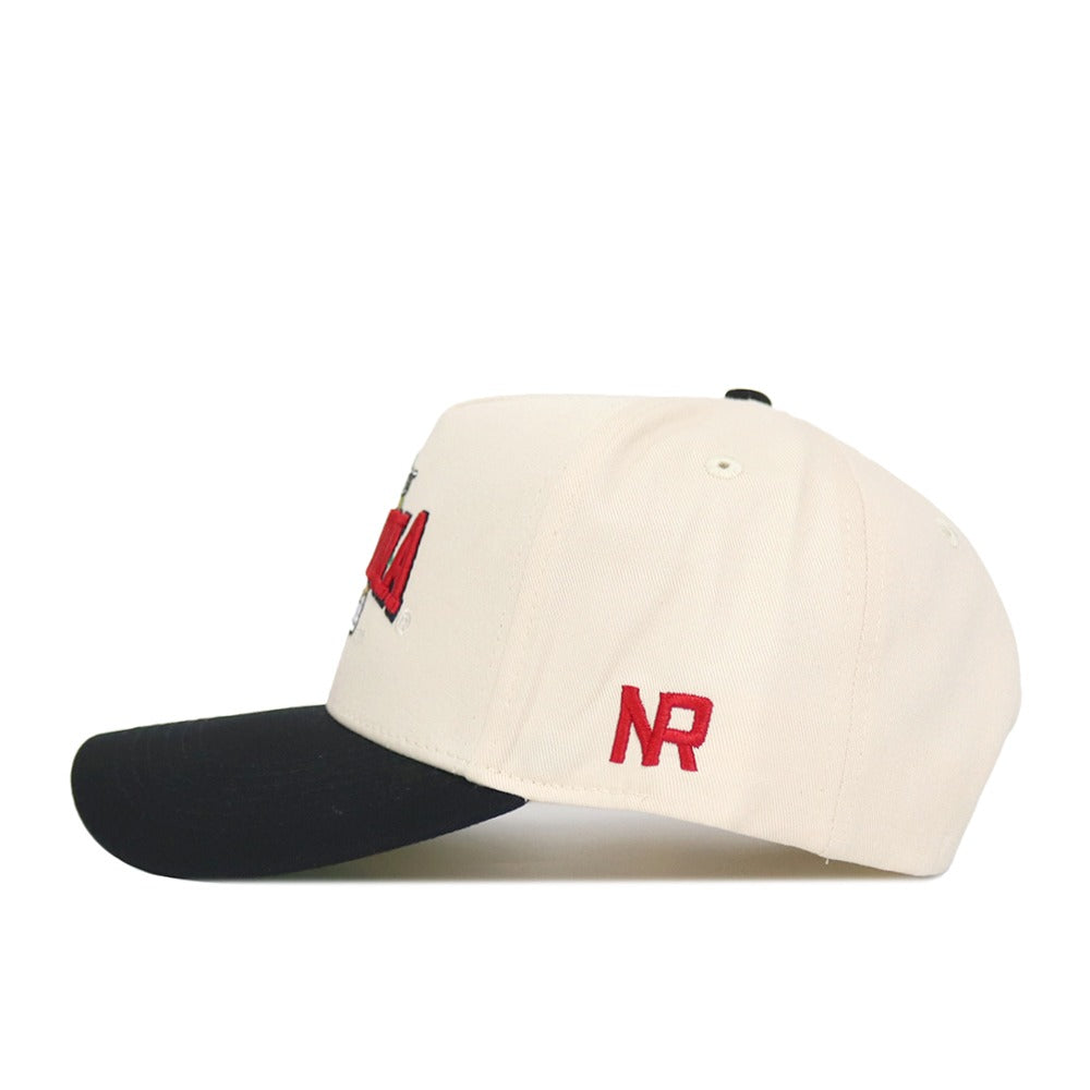 The Arizona Ballpark Hat by No Rivals is a cream-colored, structured snapback cap with a black brim and red NR embroidery on the side. Made from high-quality cotton, it combines sporty style with comfort.