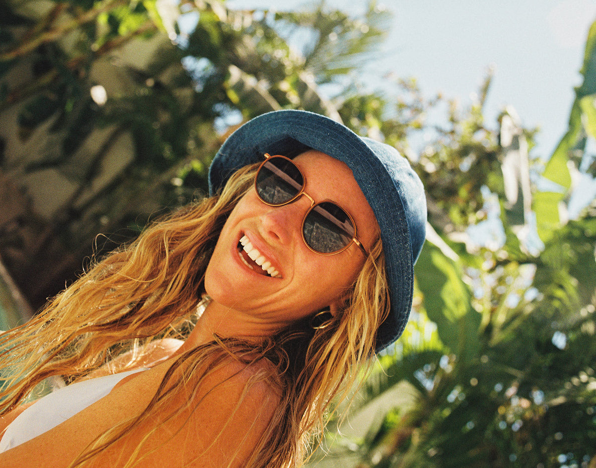 STORY baia tangerine midnight on a woman's face by the pool