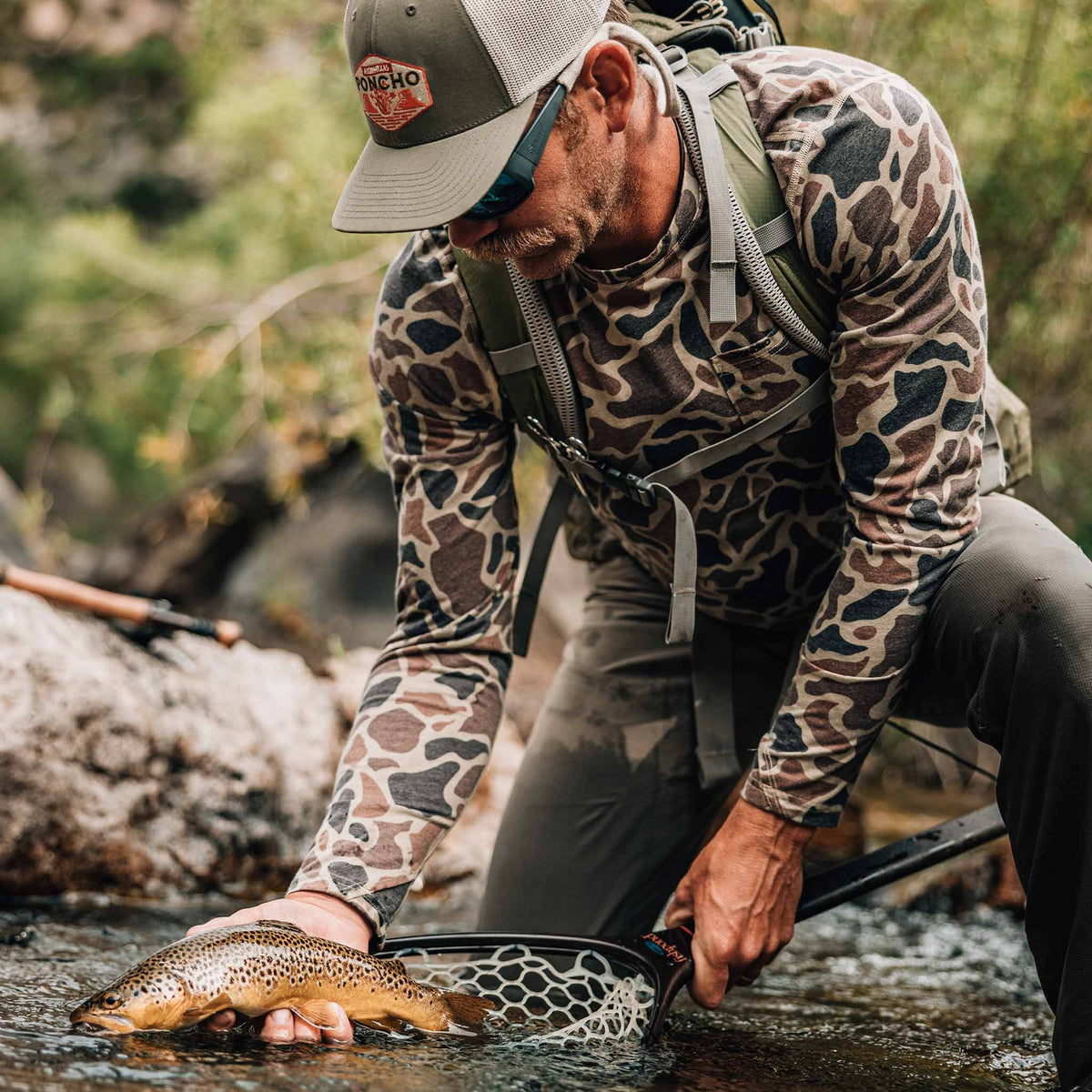 man with fish wearing camo crew