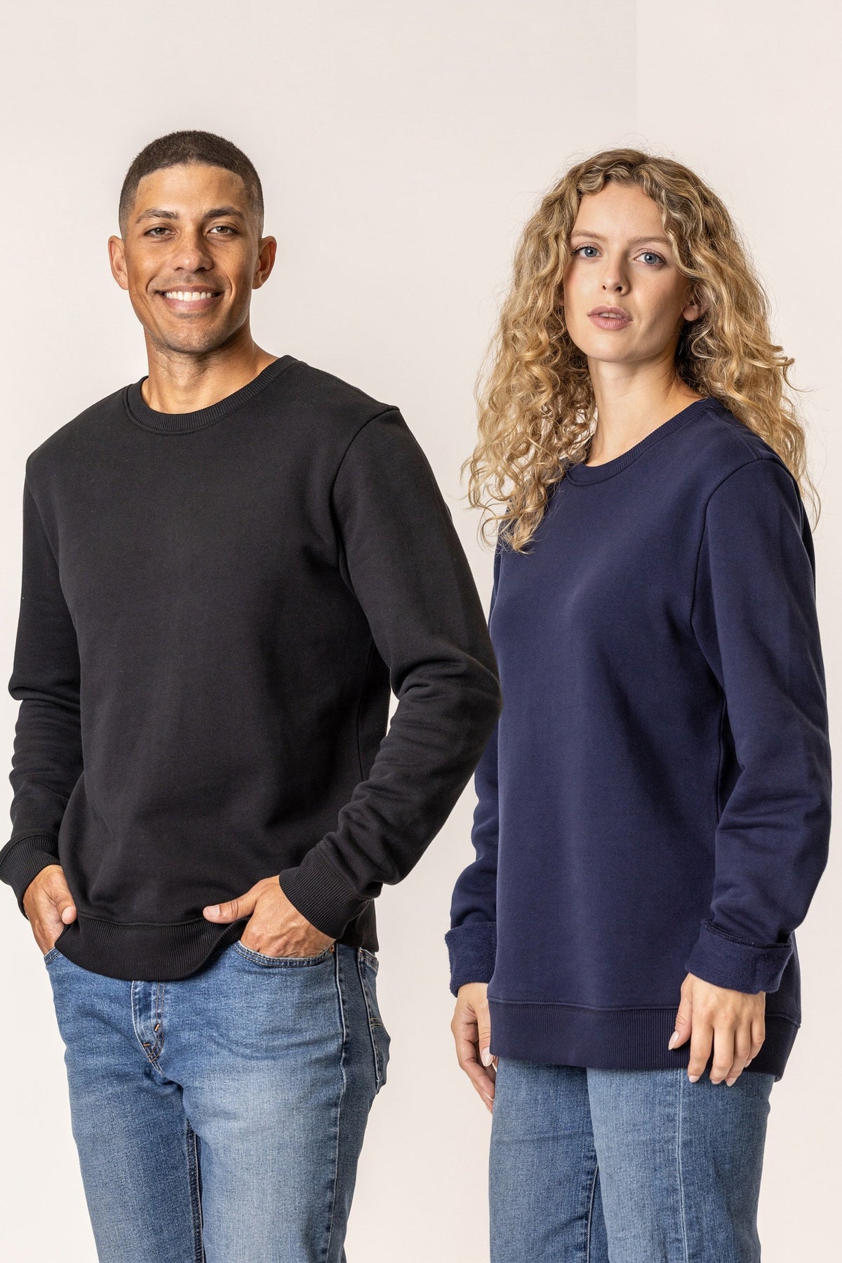 Man and woman wearing black and navy cotton sweatshirts 